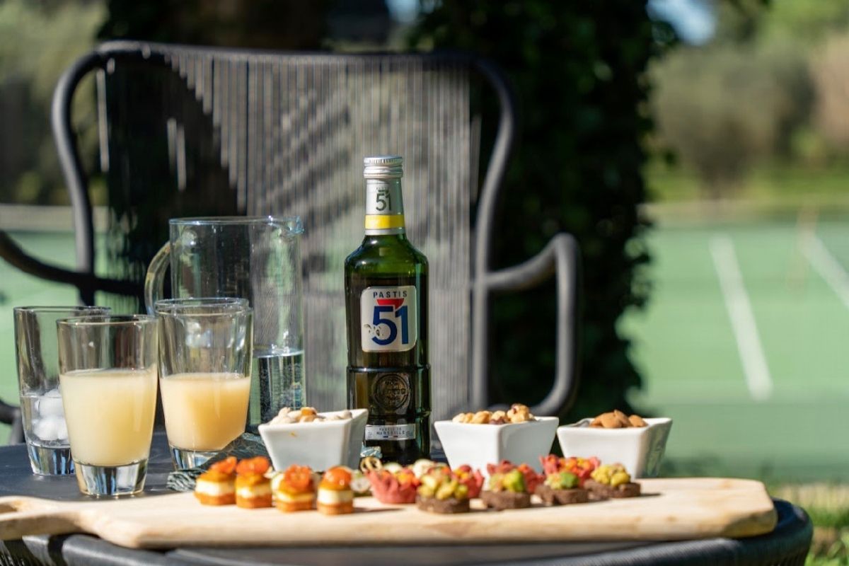 pastis beside tennis court during apéritif hour